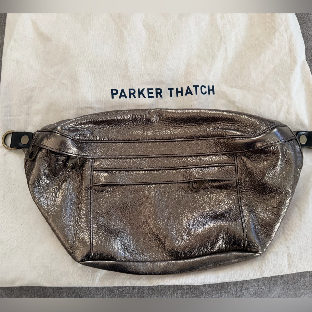 Parker Thatch “Cross Your Heart” sling in color “Gunmetal” leather.